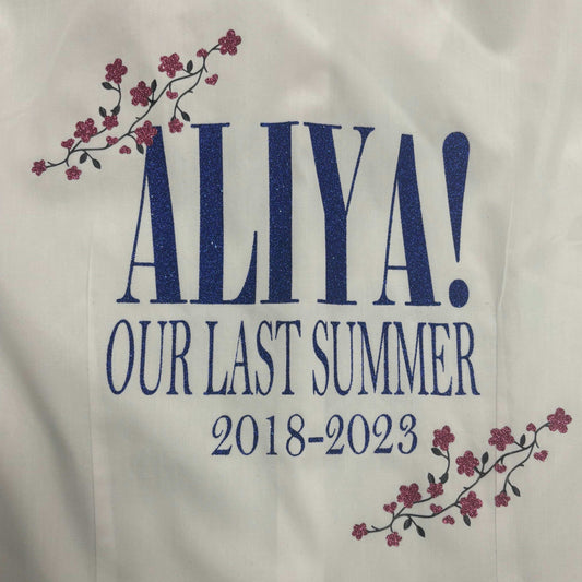 Personalised Glitter School Leavers Signing Shirts for Class Year 2024 Children. A beautiful Keepsake of Memories from the Last Day Of School. This listing is for Our Last Summer Design - From the Abba Song all in Blue Glitter Wording with Pink Glitter Flower Design. Looking for a unique way to remember your last day of school? Look no further than our Personalised Glitter School Leavers Signing Shirts!